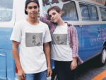 couple-wearing-different-round-neck-tees-mockup-against-a-blue-van-a16443